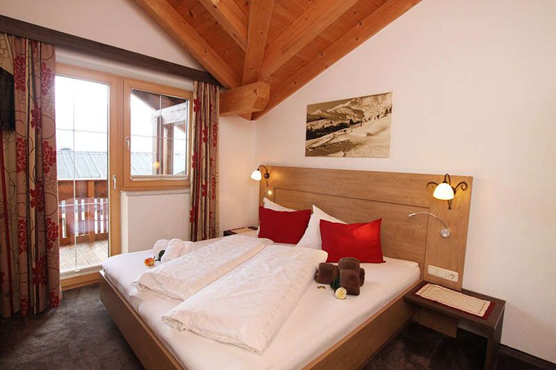   Bedroom with balcony in the Schönjoch apartment in the Alpenhof Fiss